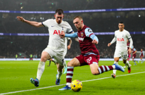 Two soccer players are competing for the ball