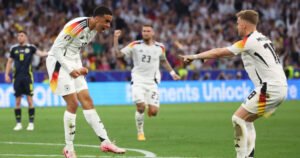 three players from the German national football team celebrating on the field